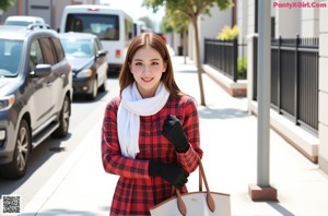 A woman in a white bra and a red plaid shirt.