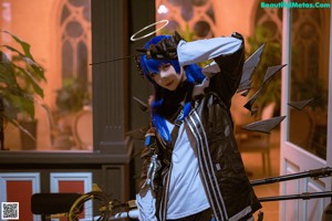 A woman with blue hair and a halo on her head.