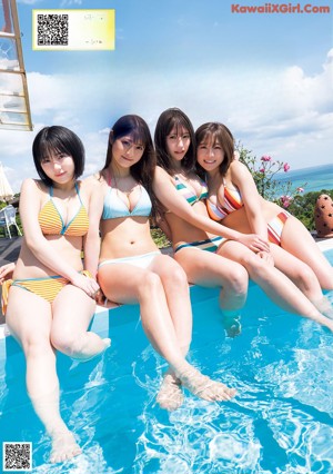 A couple of women standing next to each other on a beach.