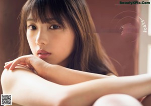 A young woman laying on a wooden table.