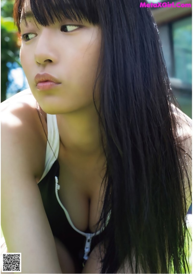 A woman with long black hair is posing for a picture.