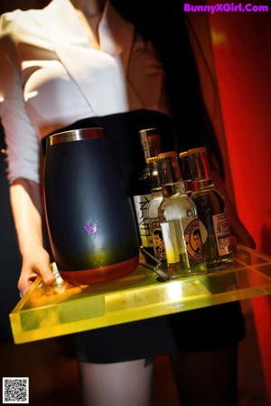 Bottles of alcohol are lined up on a table. 