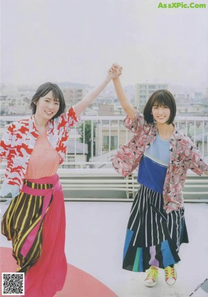 A group of young women standing on top of a lush green field.