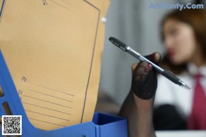 A woman sitting at a desk with a laptop computer.