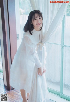 A young woman in a school uniform posing for a picture.