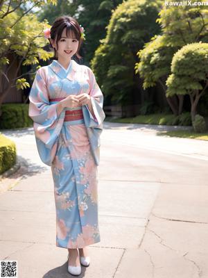 A woman in a blue kimono posing for the camera.