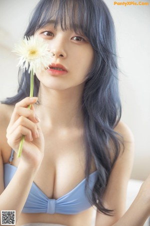 A collage of photos of a woman with blue hair.