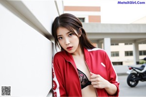 A woman in a red jacket and black lingerie posing for a picture.